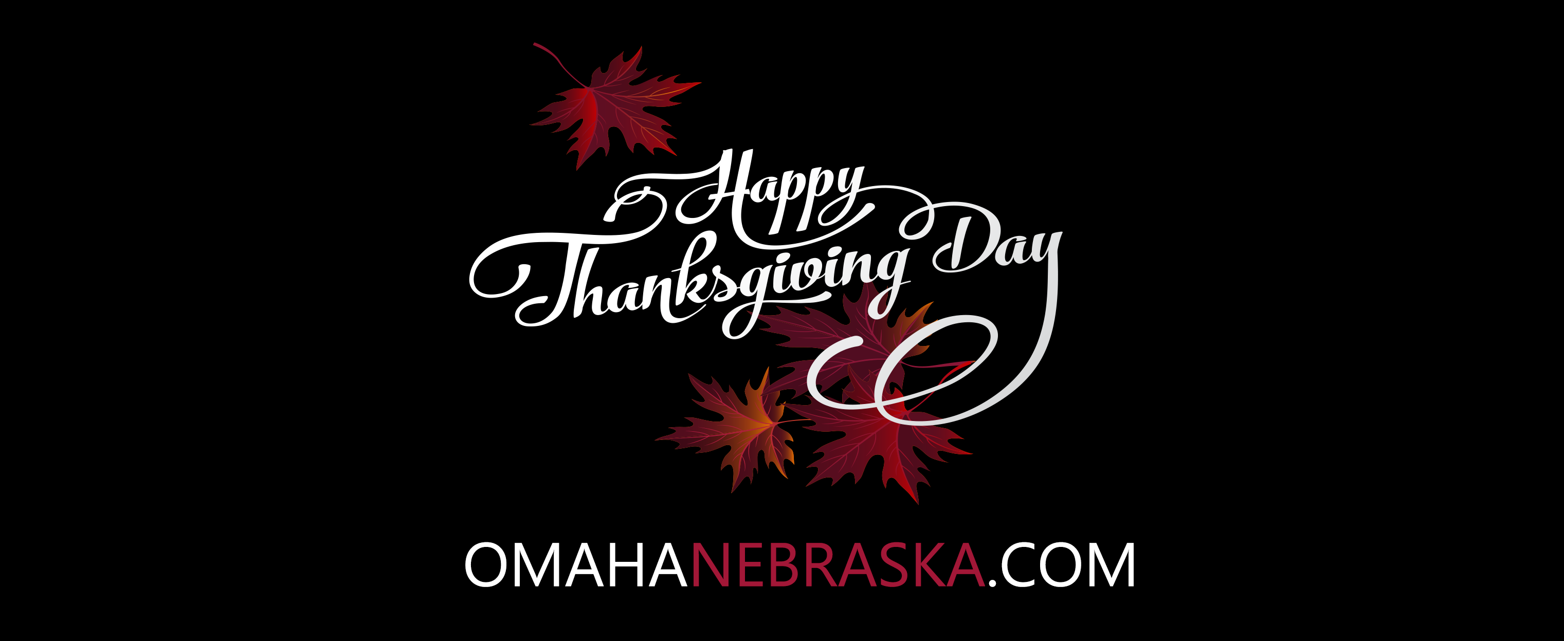 Image is white text on black background saying "Happy Thanksgiving". Below this is white and red text stating "OMAHANEBRASKA.COM". Red and rust maple leaves adorn the greeting.