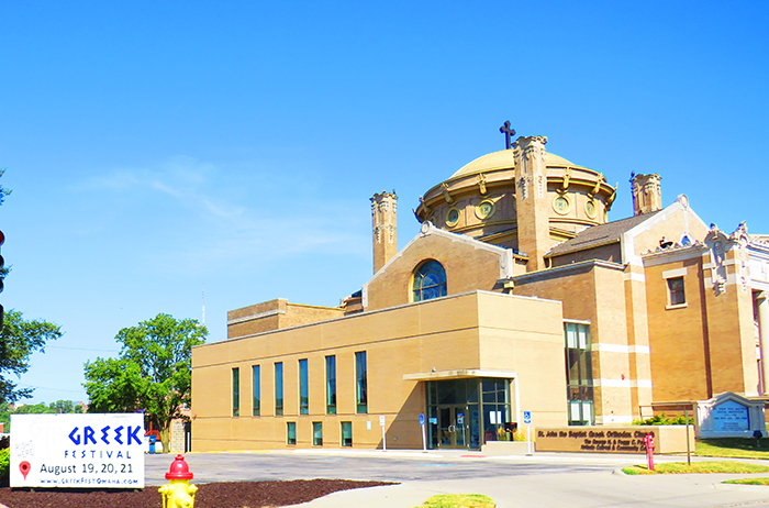 Image of St. John Church with gold dome and festival sign